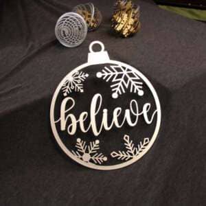 Ornament made of high quality wood and features a unique laser cut design of the word believe surrounded by snowflakes dragonfly wood arts