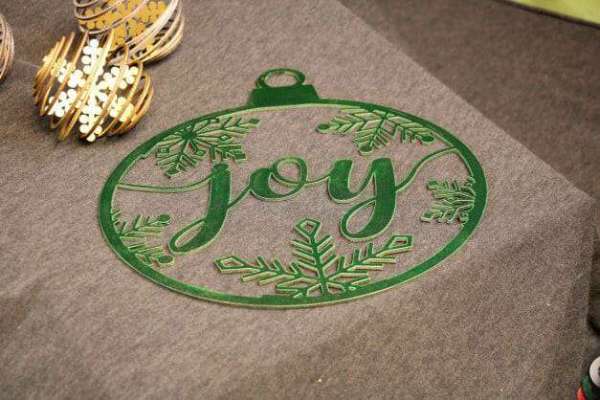 Green ornament made of high quality wood and features a unique laser cut design of the word joy surrounded by snowflakes dragonfly wood arts