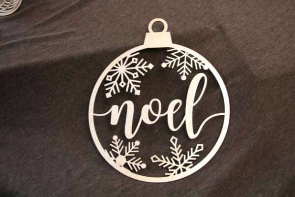 Ornament made of high quality wood and features a unique laser cut design of the word noel surrounded by snowflakes dragonfly wood arts