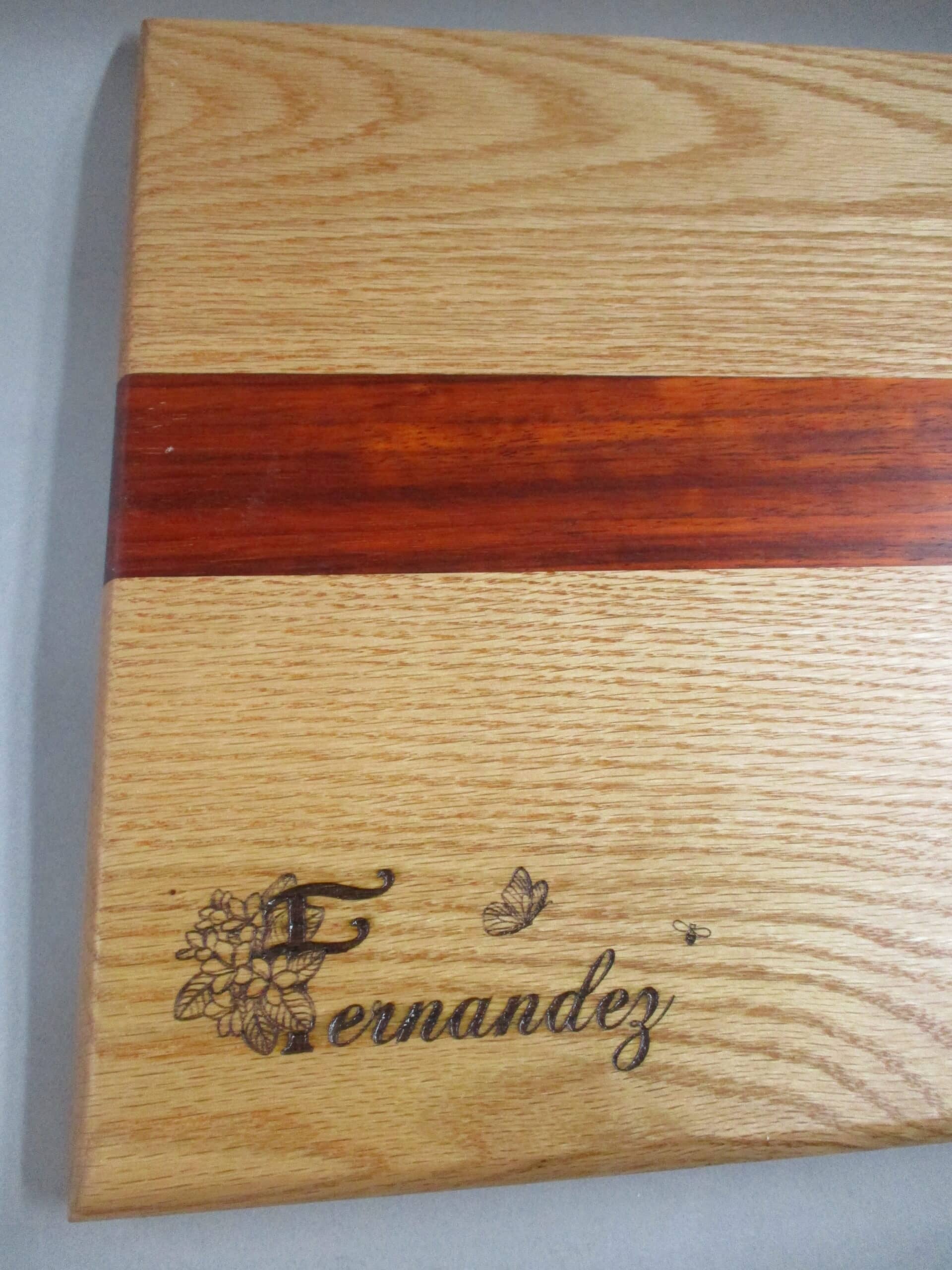 Custom engraved Oak and Padauk charcuterie board with custom artwork as a birthday gift.