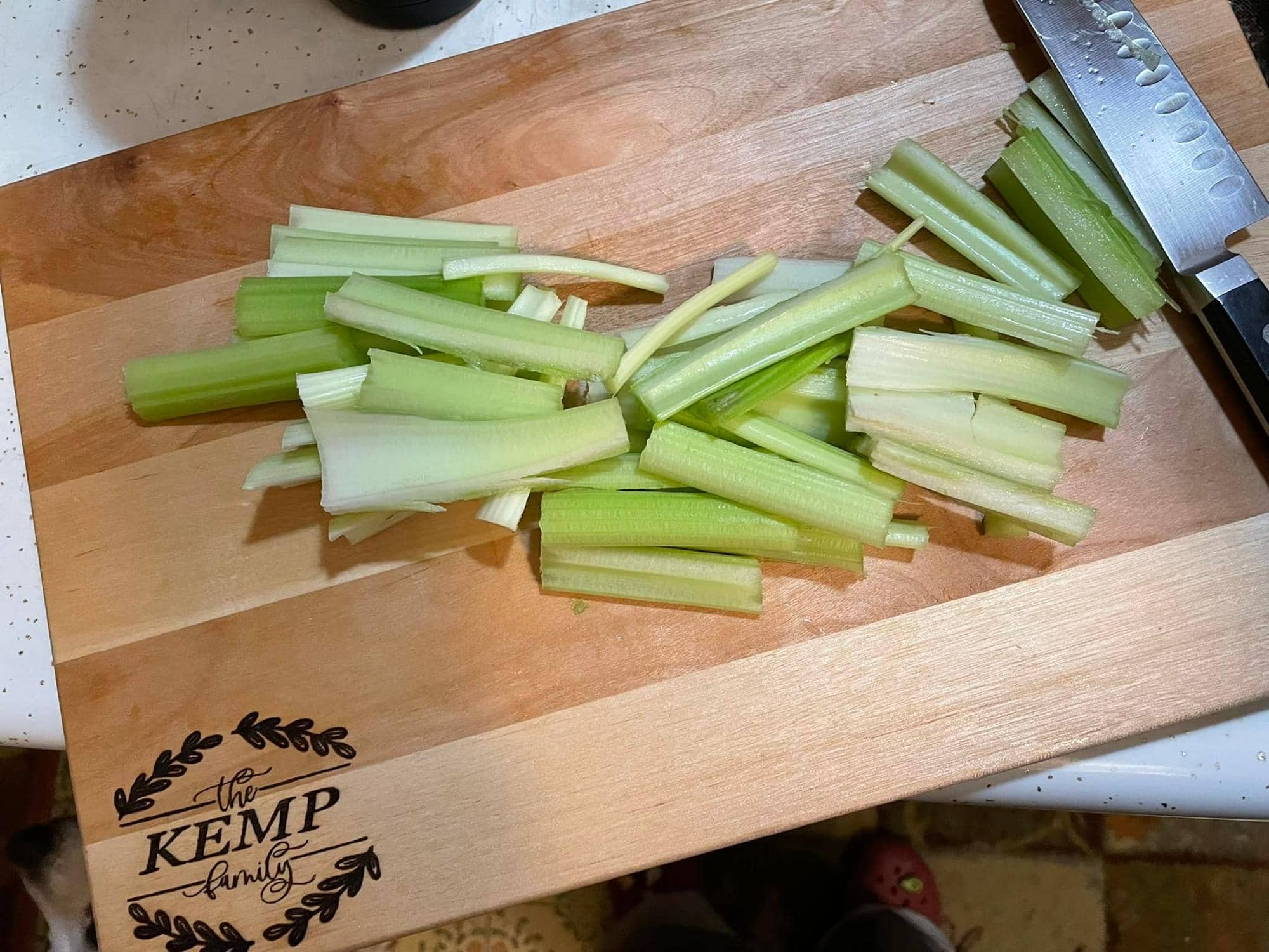 Cut Celery Sticks on a Laser Engraved Custom Cutting Board Bearing the Name Kemp