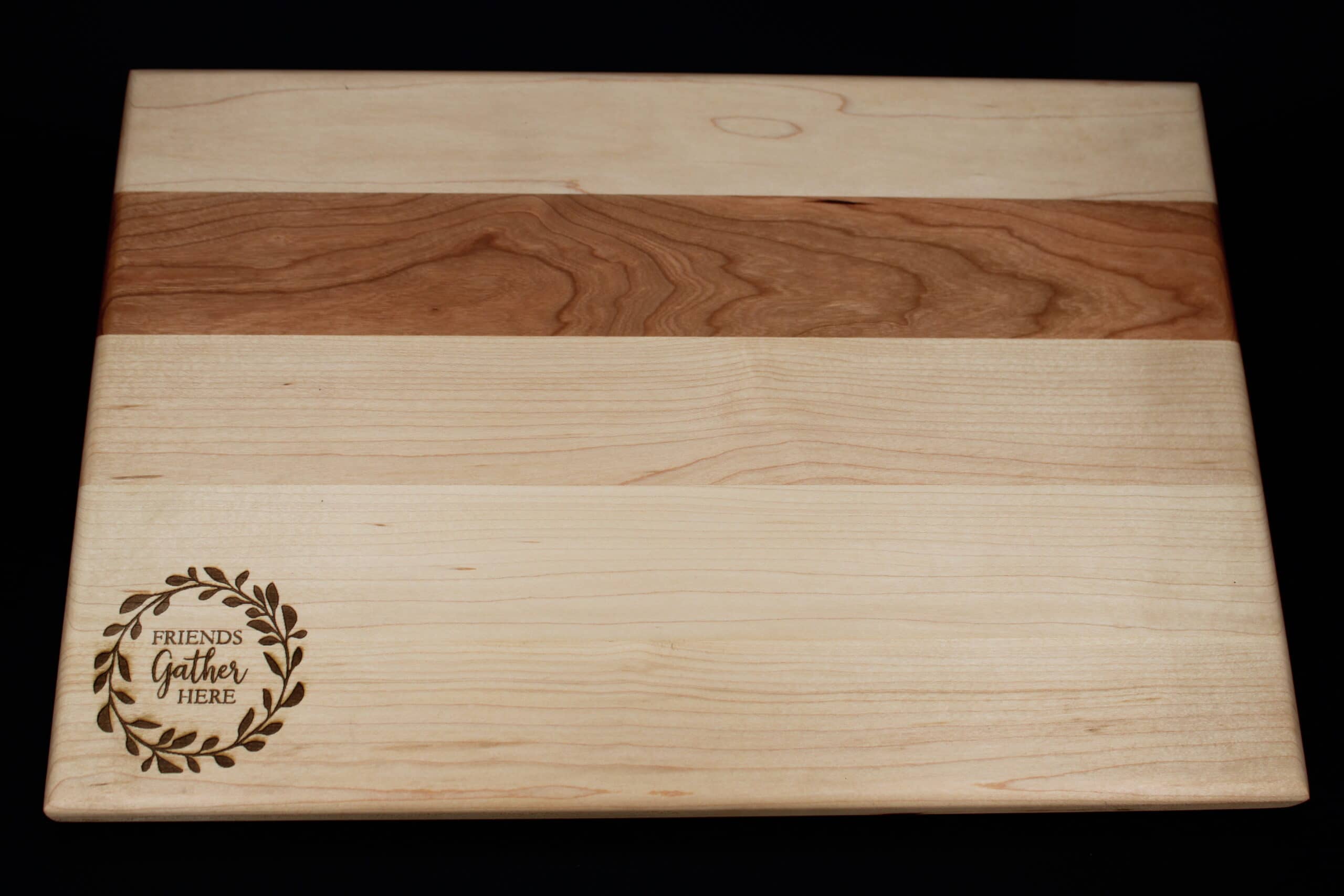 Custom friends gather here wreath engraved on Maple and Cherry cutting board/charcuterie board as a housewarming gift.