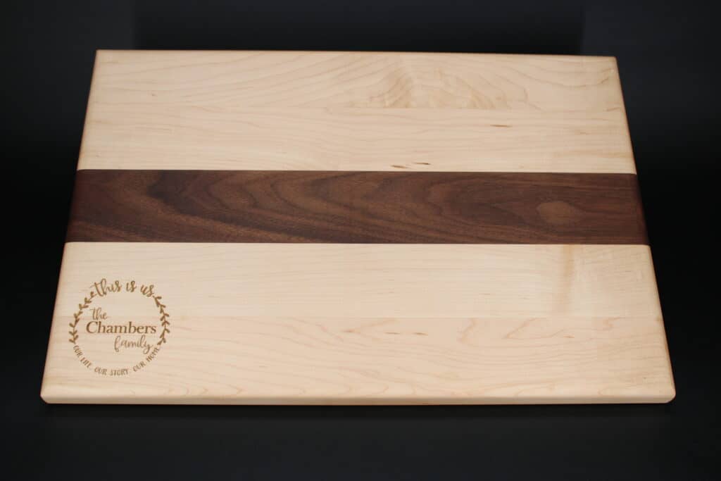 Maple and walnut charcuterie boardcutting board laser engraved with family name wreath this is us as a housewarming gift dragonfly wood arts