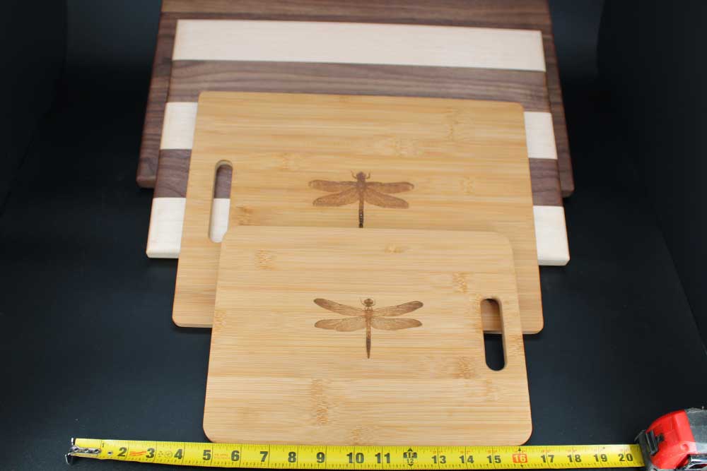 Four wood cutting boards measured to demonstrate different cutting board sizes dragonfly wood arts