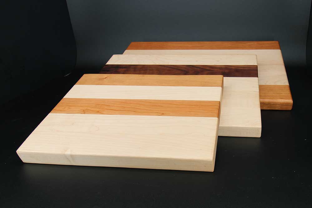 Three cutting boards made of maple wood with accents of walnut wood and cherry wood dragonfly wood arts